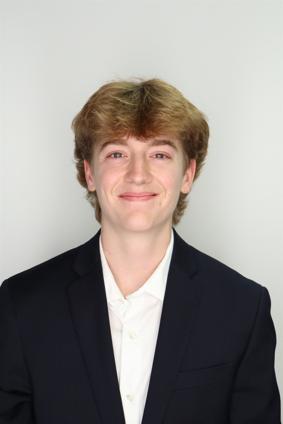 Portrait of Aaron Murphy in a navy blazer and white shirt