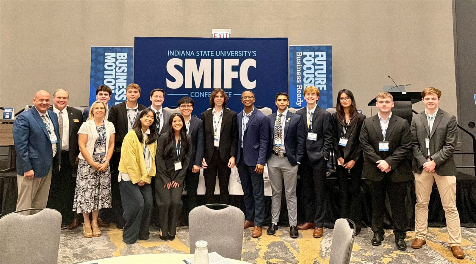 The Akron group in front of the SMIFC Conference backdrop